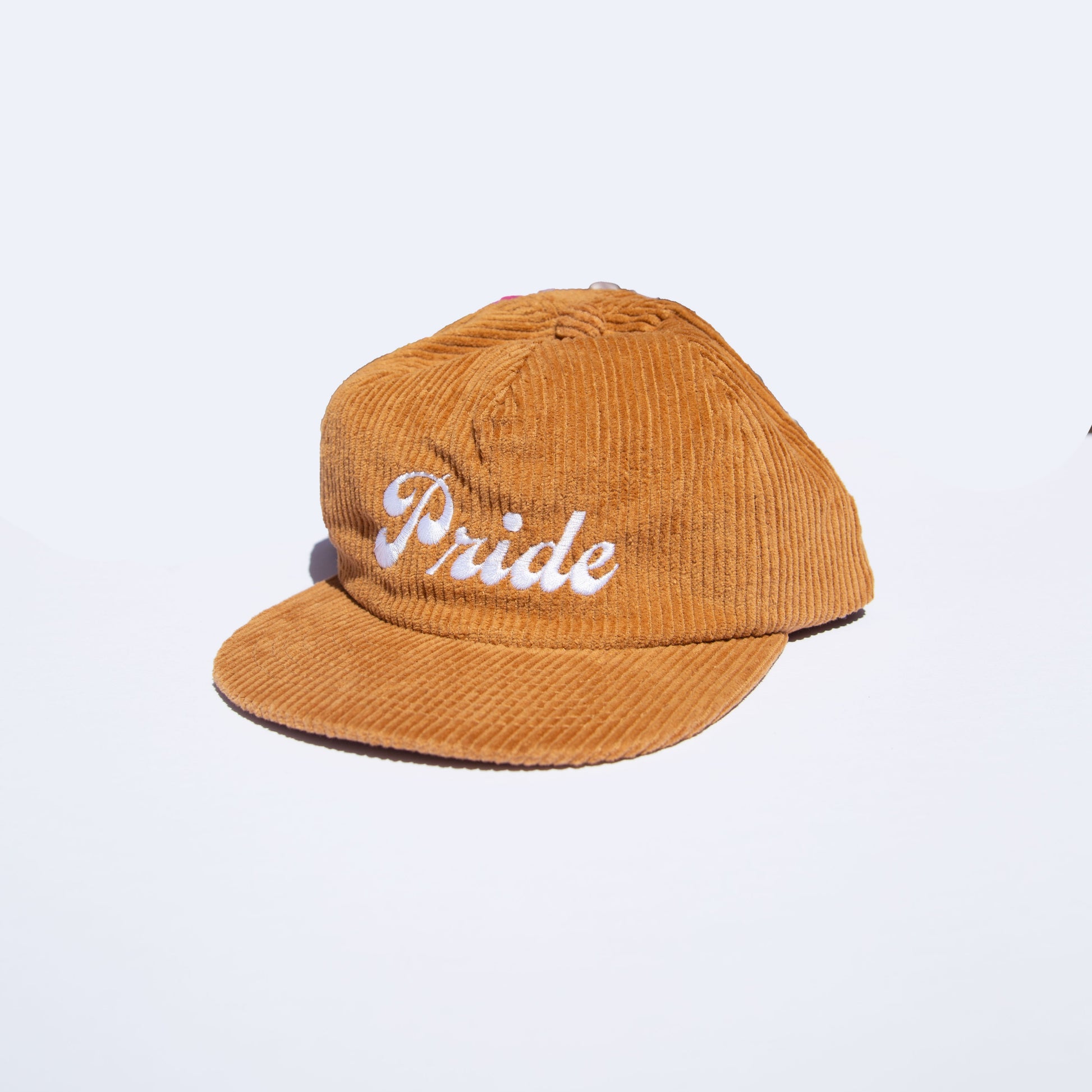 Brown corduroy hat with the text "Pride" on the front.
