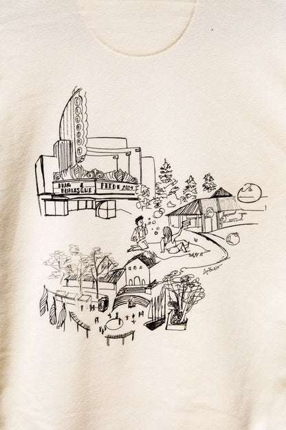 Focused image of the design for <PLACE> on the cream sweater.